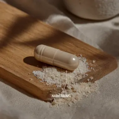 Macro shot of a single NAD+ capsule showing the high-purity white powder.